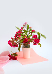 bouquet of small roses in a vase on an empty background
