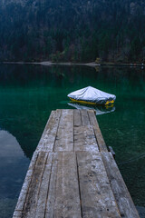 Small boat at the pier on lake Plansee in the European Alps, in Austria