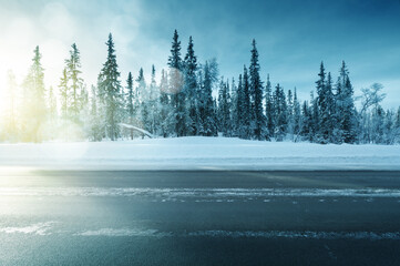 road in winter forest, sunset time