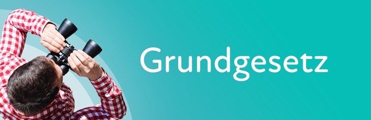 Fototapeta premium Grundgesetz. Mann mit Fernglas aus Vogelperspektive. Beobachtung, Draufsicht, Panorama. Business Text auf blau. Statistik, Wirtschaft