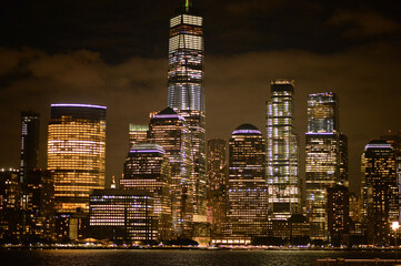 New York city skyline with illuminated buildings in the blue evening hour