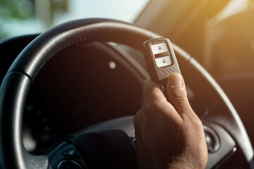 Close up of a car key and remote control in vehicle interior. Transport travel concept..