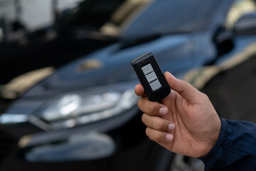 Close up car keys and remote control car alarm systems hold in hand
