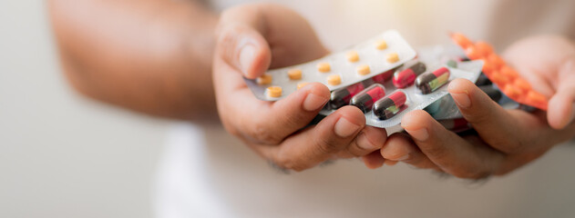 Close up of pills in hands of male holding . Health  care concept.