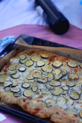 Fototapeta na wymiar Homemade gallete with cheese and zucchini, served on a picnic galette. Selective focus.