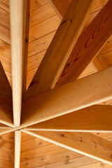 View of an pavilion roof. the wooden roof. wooden ceiling of the roof. Interior view of a wooden roof structure. Vertical format