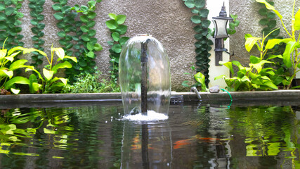 a fountain in a fish pond