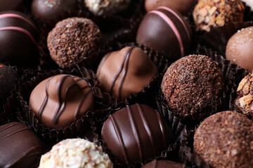 Different tasty chocolate candies as background, closeup