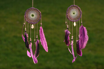 Purple dream catcher with feathers on street