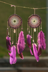 Purple dream catcher with feathers on street