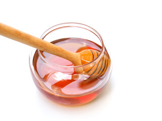 Honey in a glass jar isolated on white background