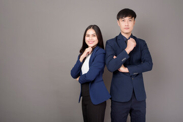 portrait of young Asian confidence business people on gray background
