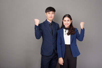 portrait of young Asian confidence business people on gray background