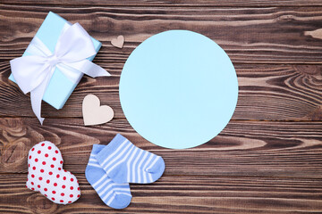 Father's day concept. Text with gift box, socks and hearts on wooden table