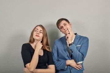 Hand on chin thinking about question, pensive expression. Doubt. Thoughtful face. Using that incredibly sharp business mind. Young attractive couple boyfriend girlfriend two people