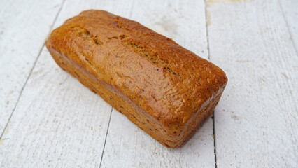 Gluten-free whole grain rye bread on the white wooden background. Healthy food concept..