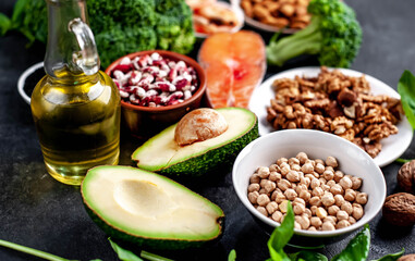 Omega 3 food sources on stone background. Foods high in fatty acids, including seafood, vegetables, nuts and seeds.