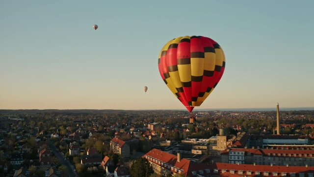 Drone Shot of Hot Air Balloons Floating Above City Village During Sunset