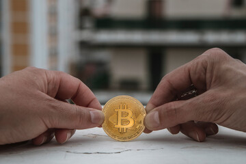 Two hands on both sides of a coin, a bitcoin with a digital currency concept