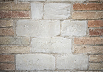 Close up of a clunch wall , soft limestone blocks supported by house bricks either side.