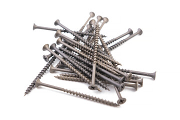 Long black wood screws on a white isolated background.