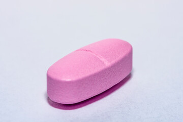closeup of three pink pills, Pink pill vitamin medicine.