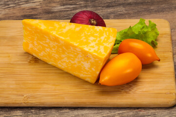 Marble cheese  triangle over wooden