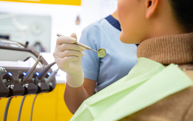 Close-up of patient's open mouth during oral checkup with mirror