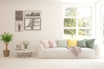 White living room with sofa and summer landscape in window. Scandinavian interior design. 3D illustration