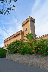 Fototapeta na wymiar view of the Bolgheri castle of medieval origin which stands at the end of the famous Viale dei Cipressi in the town of Castagneto Carducci in Livorno, Tuscany, Italy.
