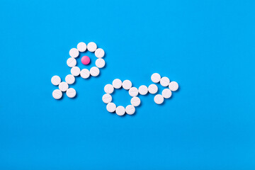gender symbol male and female of pills on blue background top view with copy space, couple health and infertility.