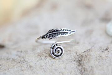 White metal silver ornamental ring with feather shape