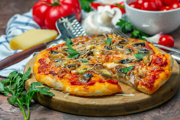 Pizza with mushrooms and cheese cut into pieces.