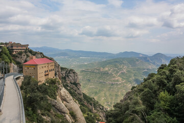 Fototapeta na wymiar Spain. Catalonia - 30 AUGUST 2014. View from the top of the Montserrat Mountains and the Montserrat Monastery in the lower part