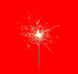 Beautiful sparkler burning on red background. Party decor