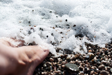 Close-up of female feet standing on the shore