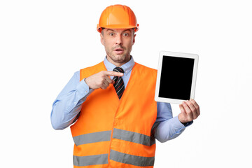Surprised Worker Man Showing Tablet Screen On White Studio Background