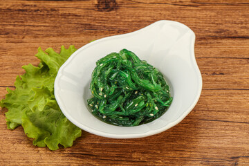 Green Chuka Seaweed Salad Isolated on White Background Top View. Wakame Sea Kelp Salat
