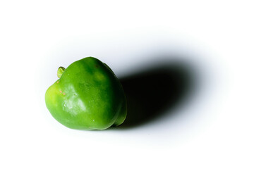 An isolated raw green capsicum in a white background