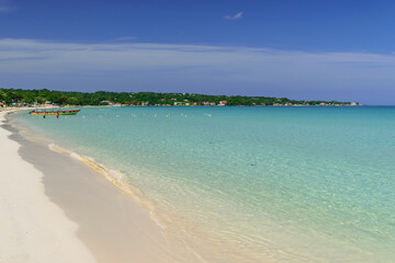 Tropical Caribbean island clear blue ocean water on sunny summer day in Negril, Jamaica. Glass...