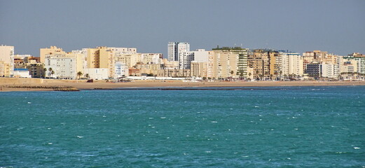 Cityscape of Cadiz town in southern Spain. Blue sky and sea.