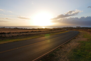 Sunset view from the Kaanapali hillside, road leading down to the beach
