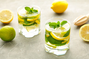 Water detox with lemon, lime and mint on a grey concrete background