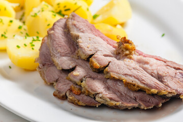 slowly roasted lamb on garlic with potatoes