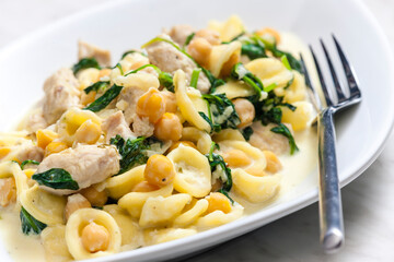 pasta orecchiette with chicken meat, chick peas and spinach