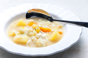 cauliflower soup with carrot, potato and egg