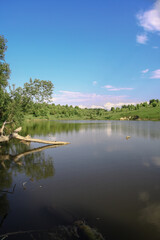 Beautiful river in the highlands in summer. Lake in an ecologically clean park reserve on a background of hills. A pretty landscape in the spring. Stock photo for design