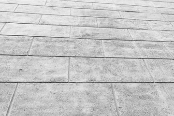 Plastered gray wall of the building, imitation of slabs and bricks. Black and white photo