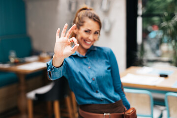 Beautiful young waitress working in exclusive restaurant.