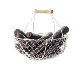 Raw black carrots in metal basket isolated on white